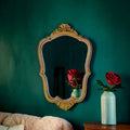 Miroir mural doré de style rocaille en résine ancienne